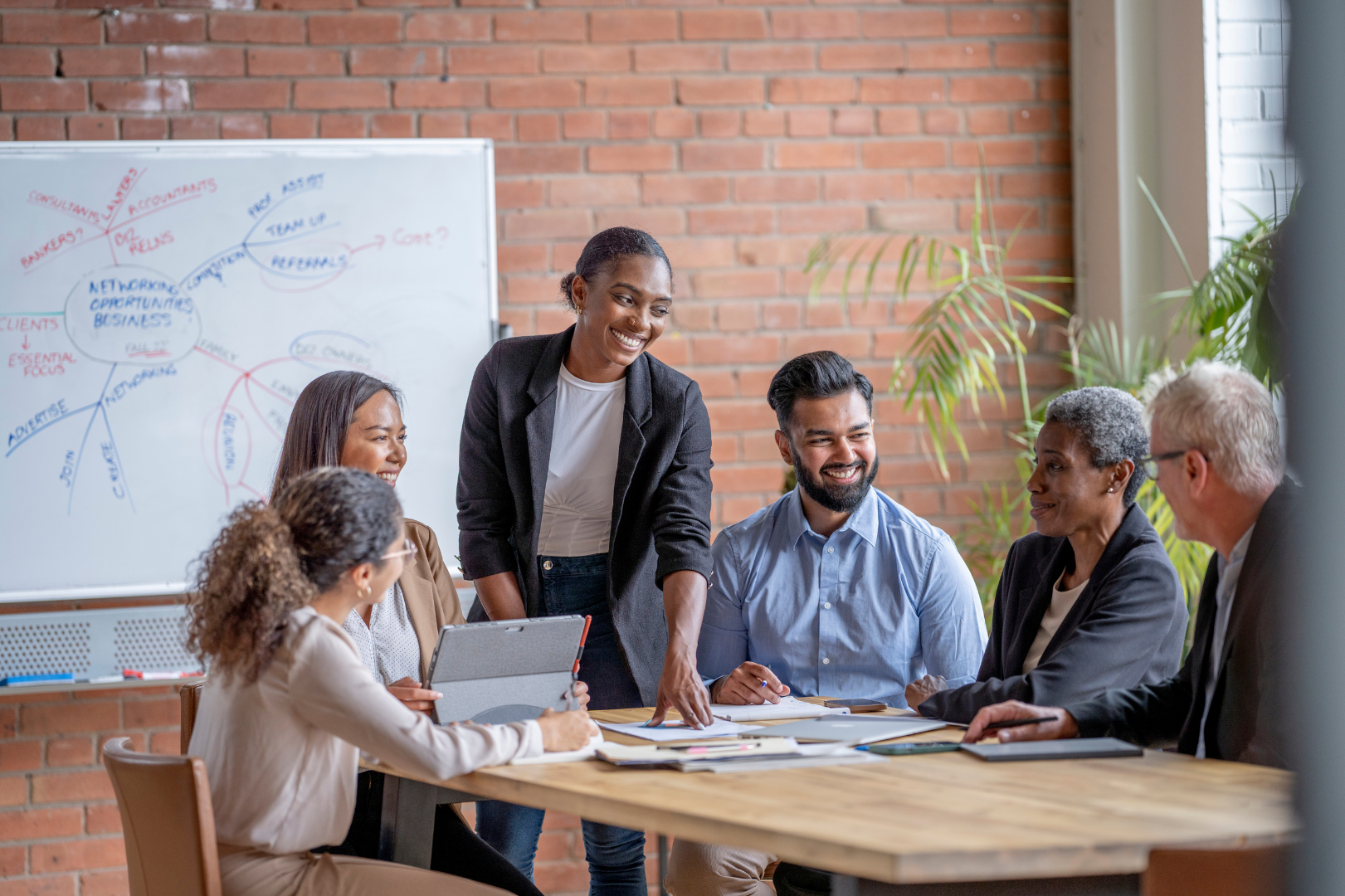 People working in an office smiling with dashboard