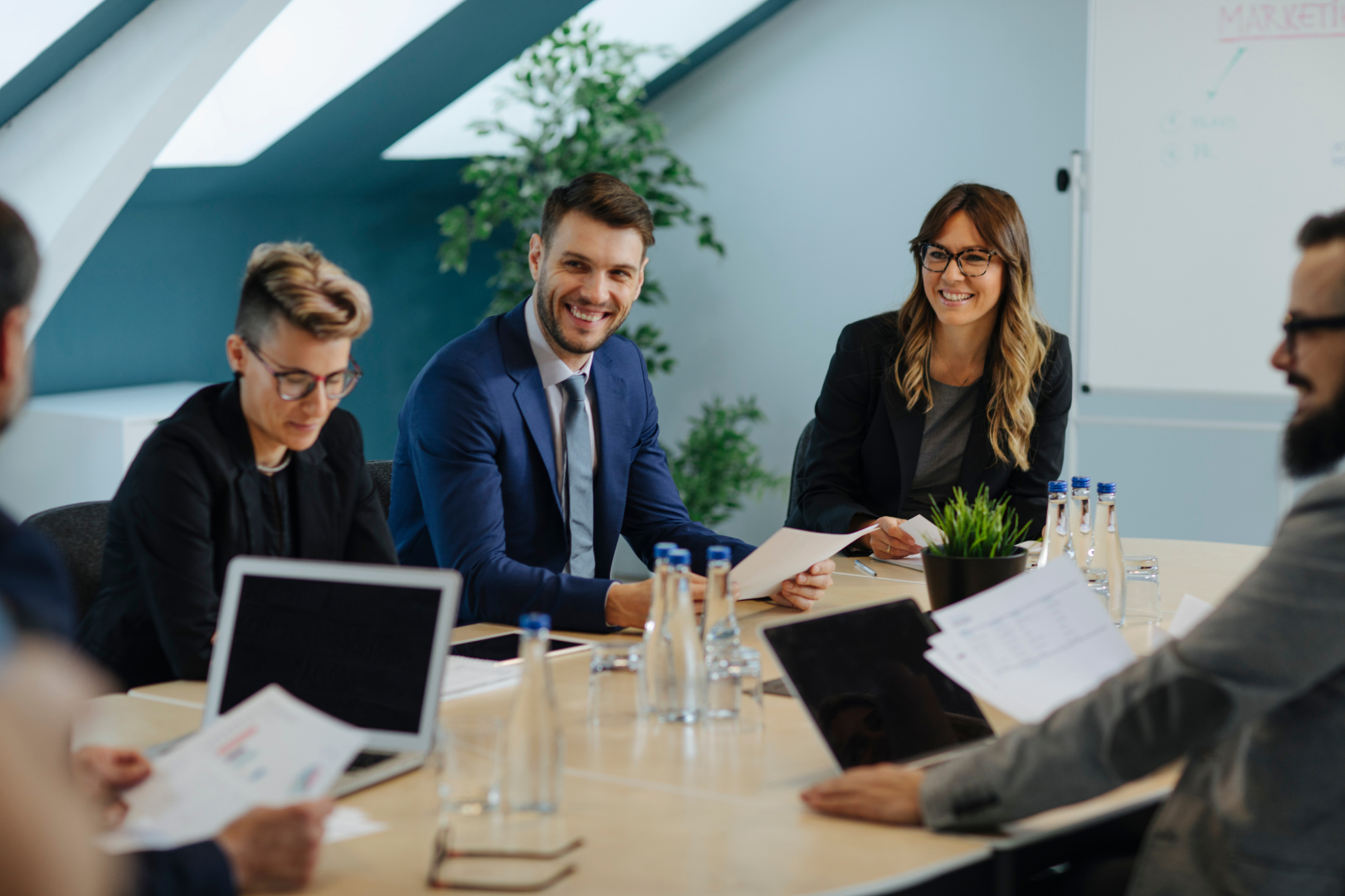 People working in an office with laptops and paper