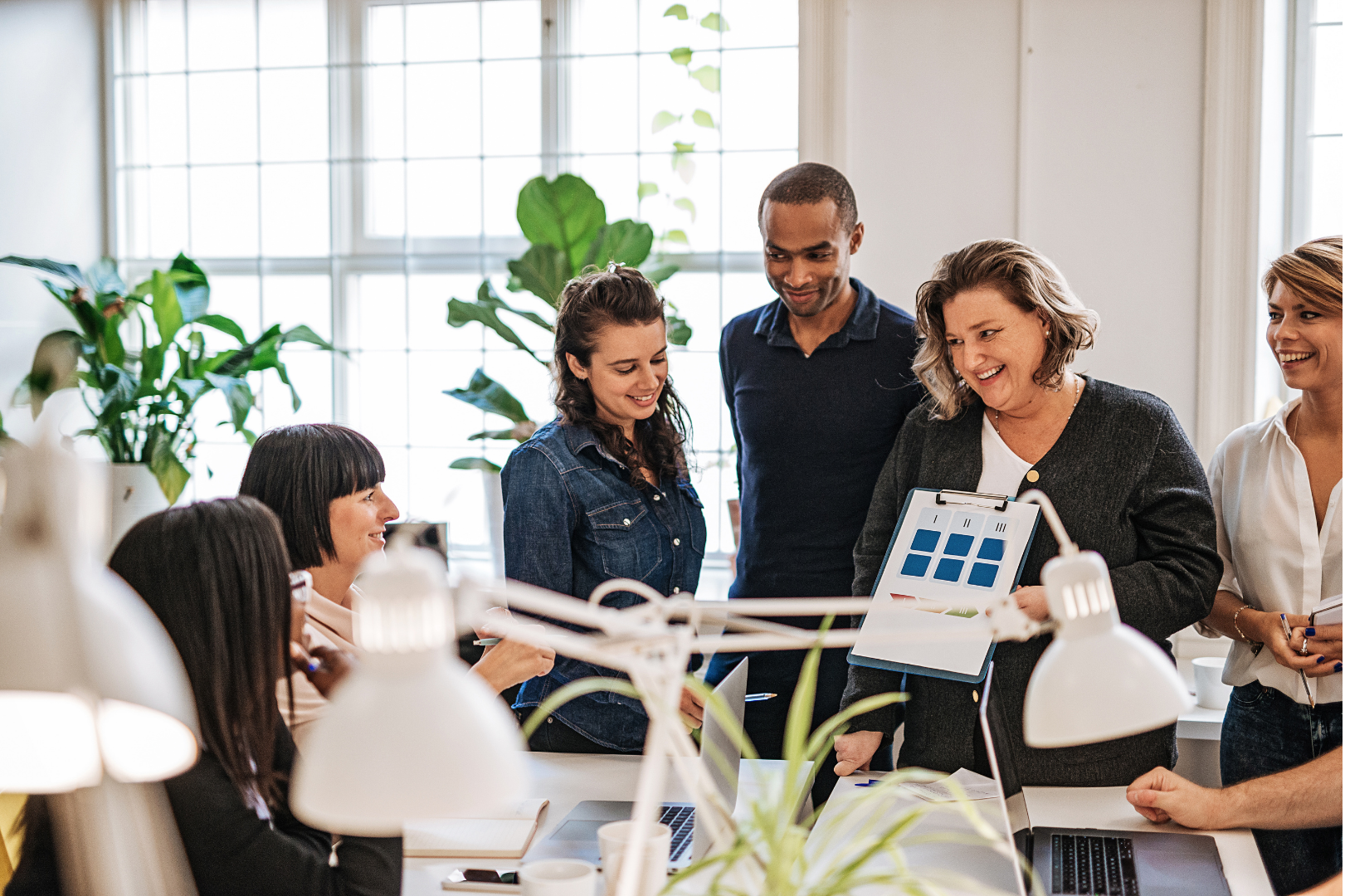 Team of people working in an office with tablets